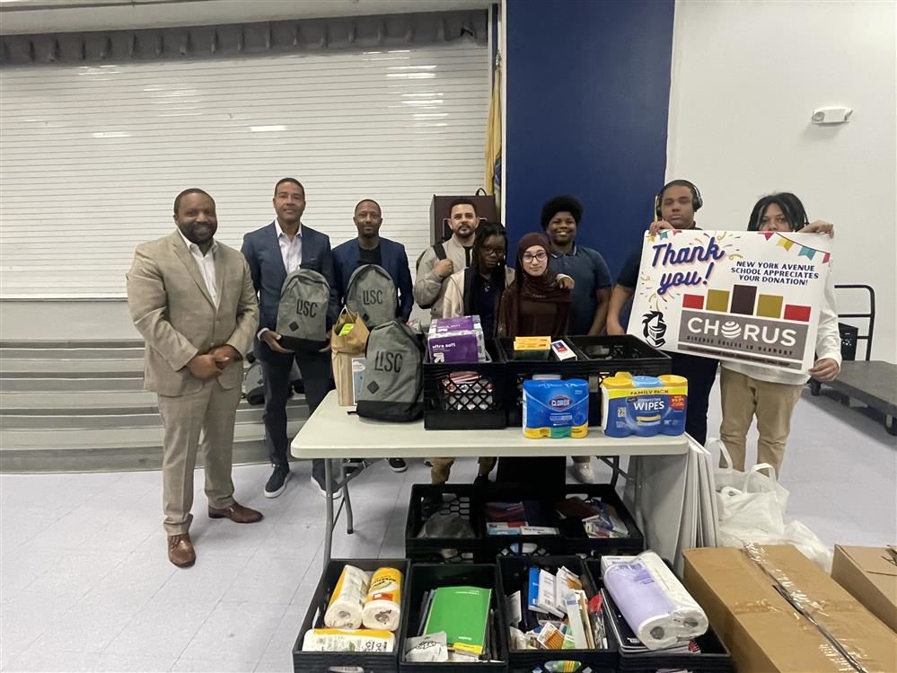 New York Avenue School Principal Kendall Williams and members of student council accept Caesars donation of school supplies.